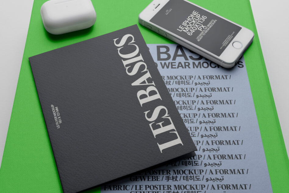 Flat lay of poster, phone, wireless earbuds on bright green background