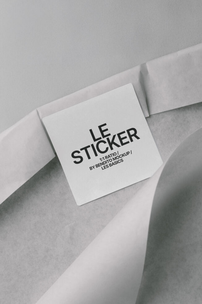White square sticker mockup on crumpled paper with Les Basics text