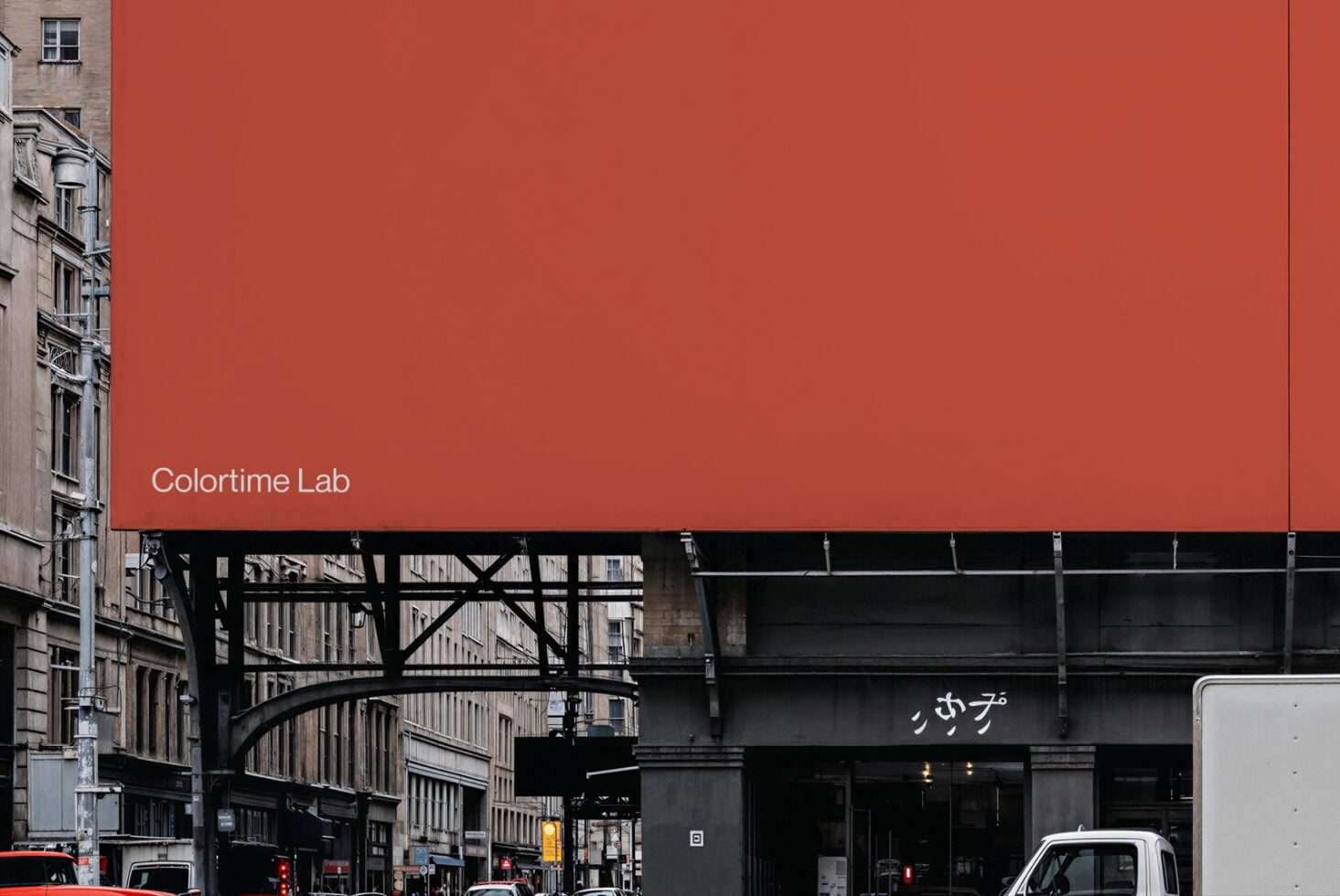 Bright red billboard with Colortime Lab text on urban street corner