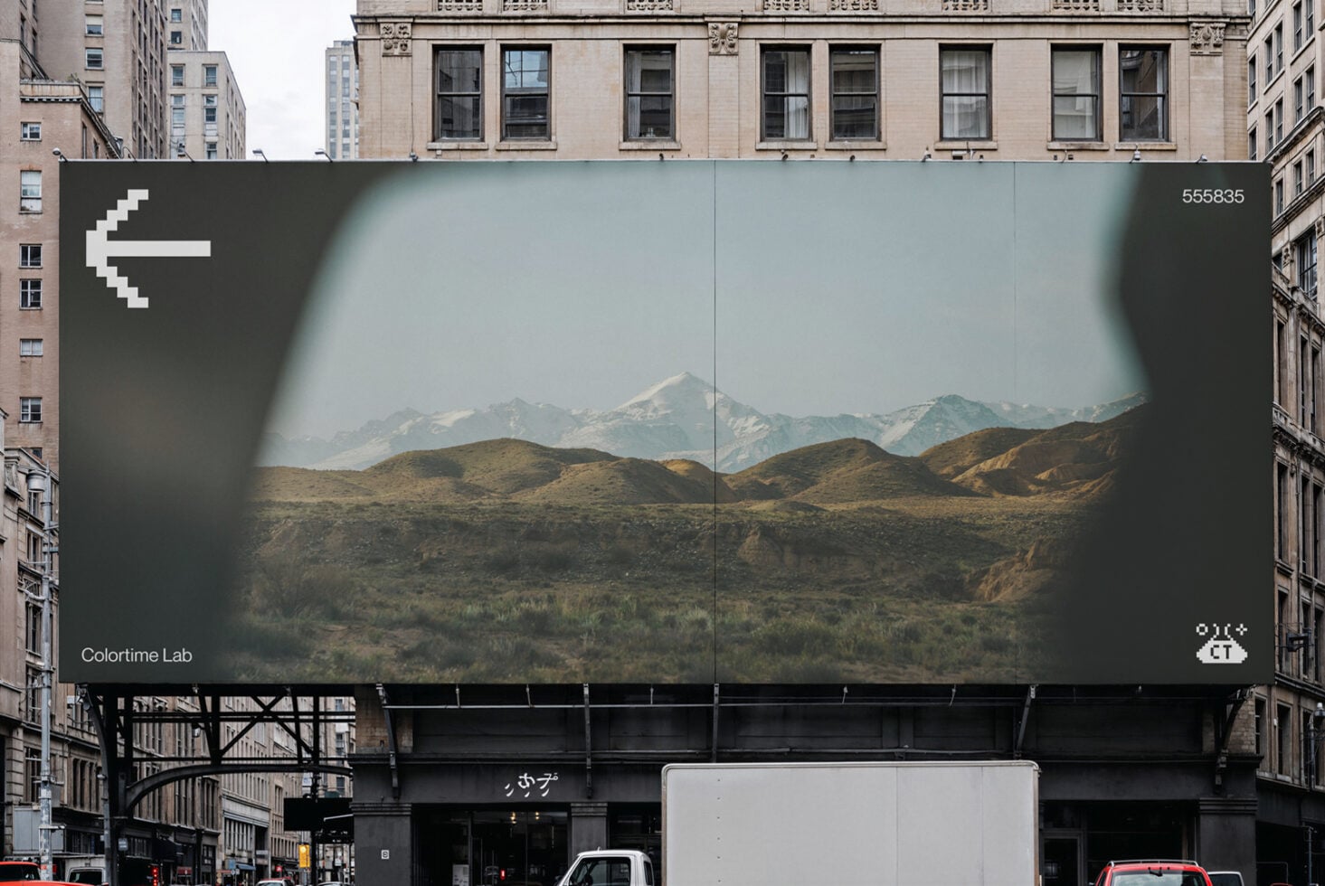 Urban billboard mockup showing mountain landscape between skyscrapers
