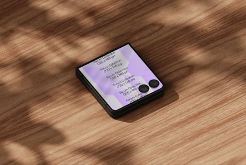 Folded phone mockup on wood surface showing purple design with dual camera