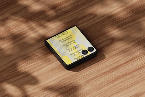 Folded phone mockup on wood surface showing yellow design with dual camera