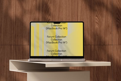 MacBook Pro 14 inch with yellow geometric layout on white shelf