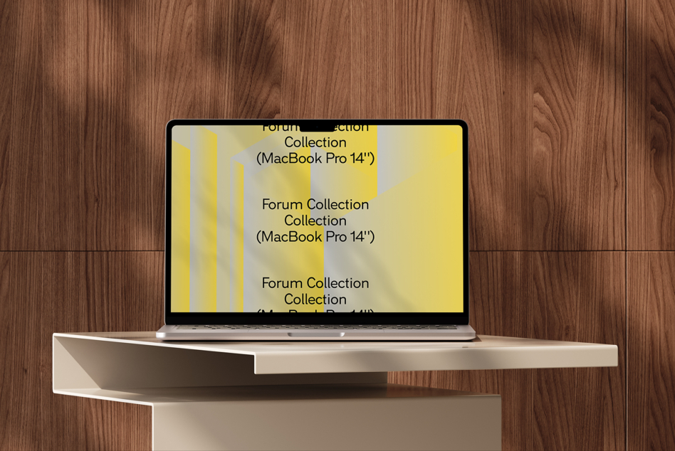 MacBook Pro 14 inch with yellow geometric layout on white shelf