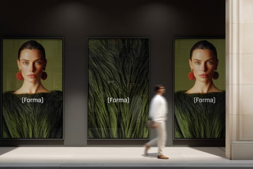 Retail display window showing three large portrait frames with figure
