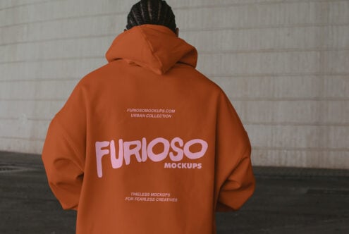 Back view of person wearing orange hoodie with pink logo print