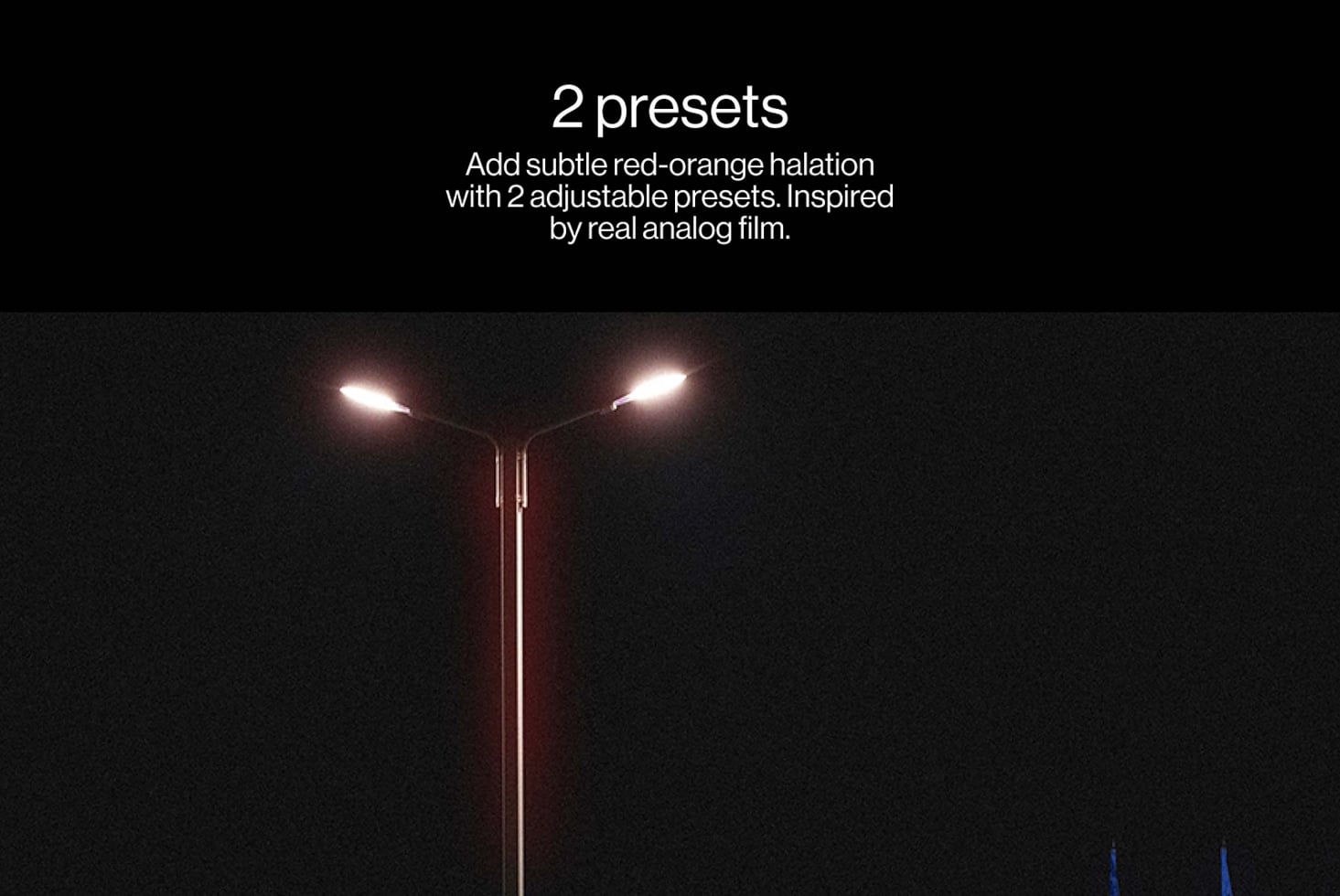 Night streetlamp glowing with red-orange halation effect against dark sky