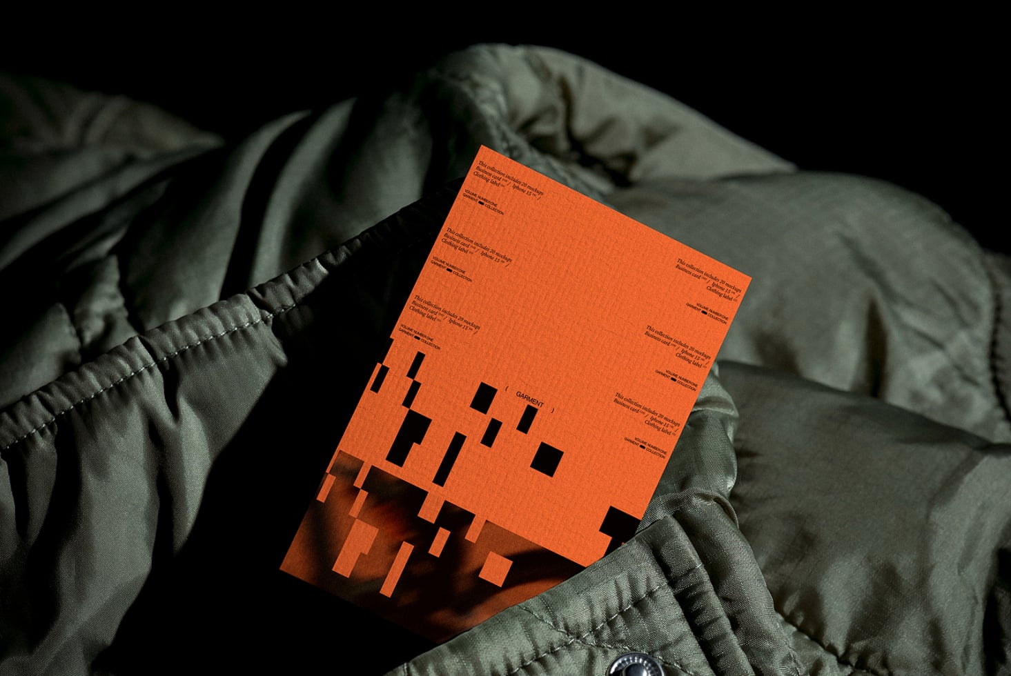 Orange clothing label mockup draped on green quilted fabric with dramatic shadows