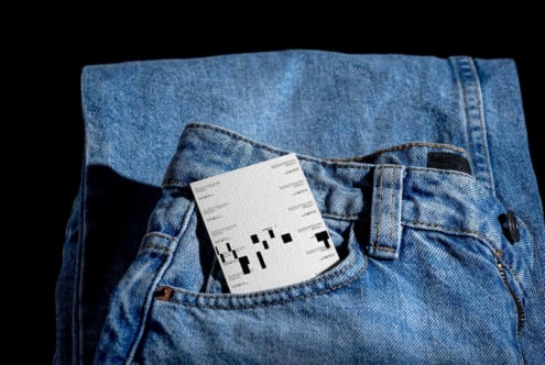 White label mockup tucked in blue jeans pocket, minimal product shot