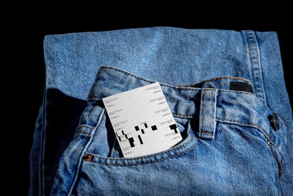 White label mockup tucked in blue jeans pocket, minimal product shot