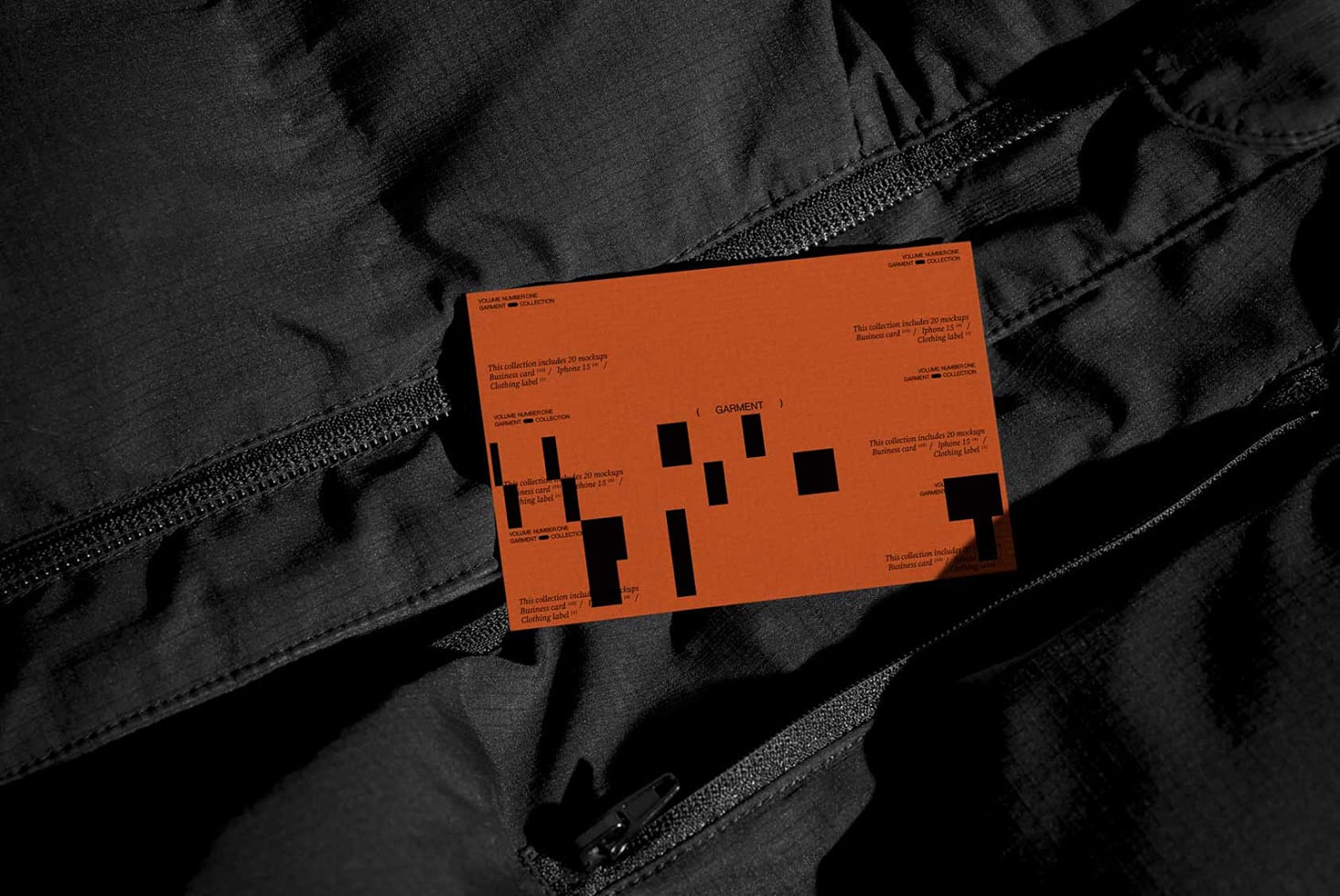 Orange clothing label mockup on black fabric with zipper detail