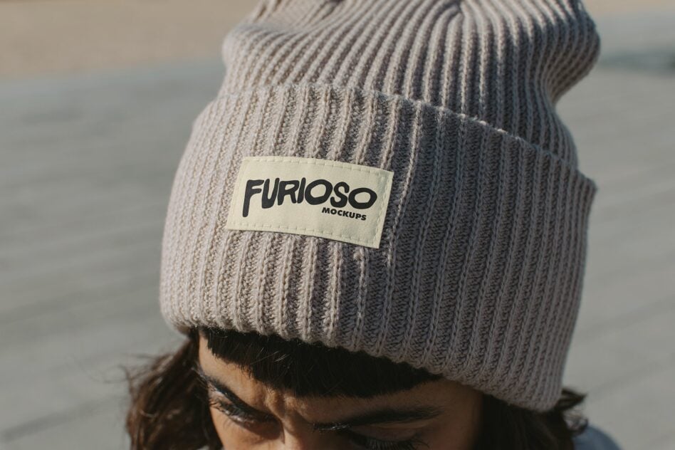 Gray knit beanie with cream woven label displaying Furioso text