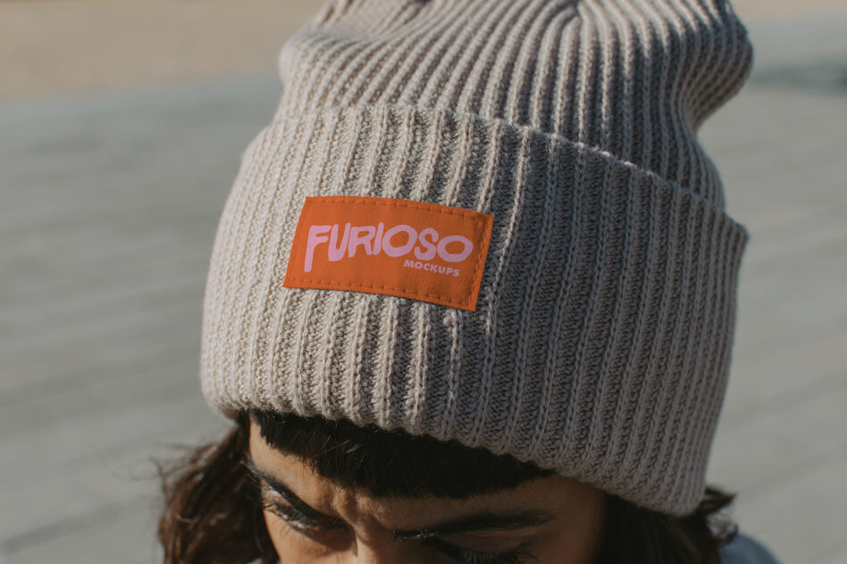 Cream ribbed beanie with orange woven label showing Furioso branding
