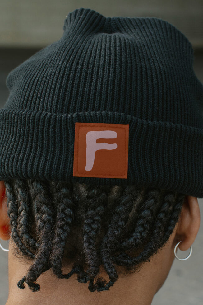 Woven label on dark green ribbed beanie back view