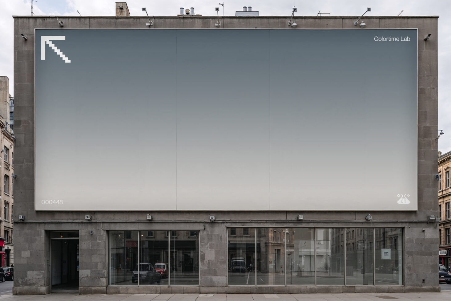 Rooftop billboard with gradient gray fade, minimal logo in corner