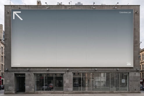 Rooftop billboard with gradient gray fade, minimal logo in corner