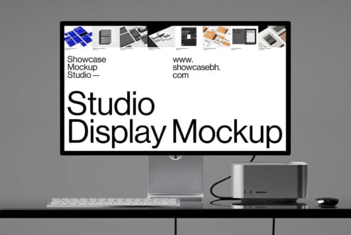 Studio display mockup on desk with keyboard mouse speaker showing white background