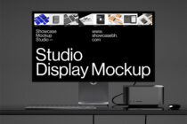 Studio display mockup on desk with keyboard mouse speaker showing black background