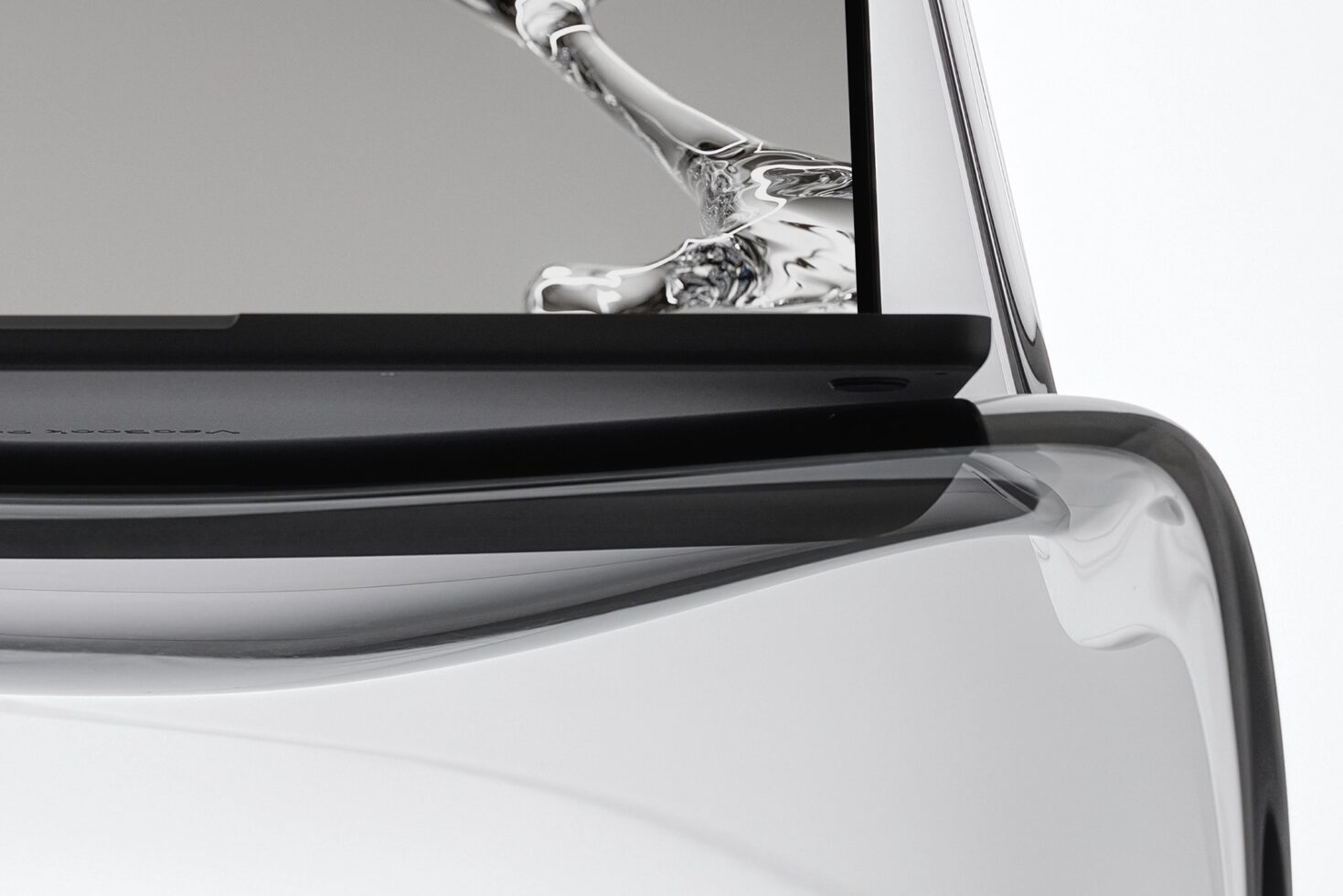 Laptop screen with hand gesture showing abstract liquid design close up