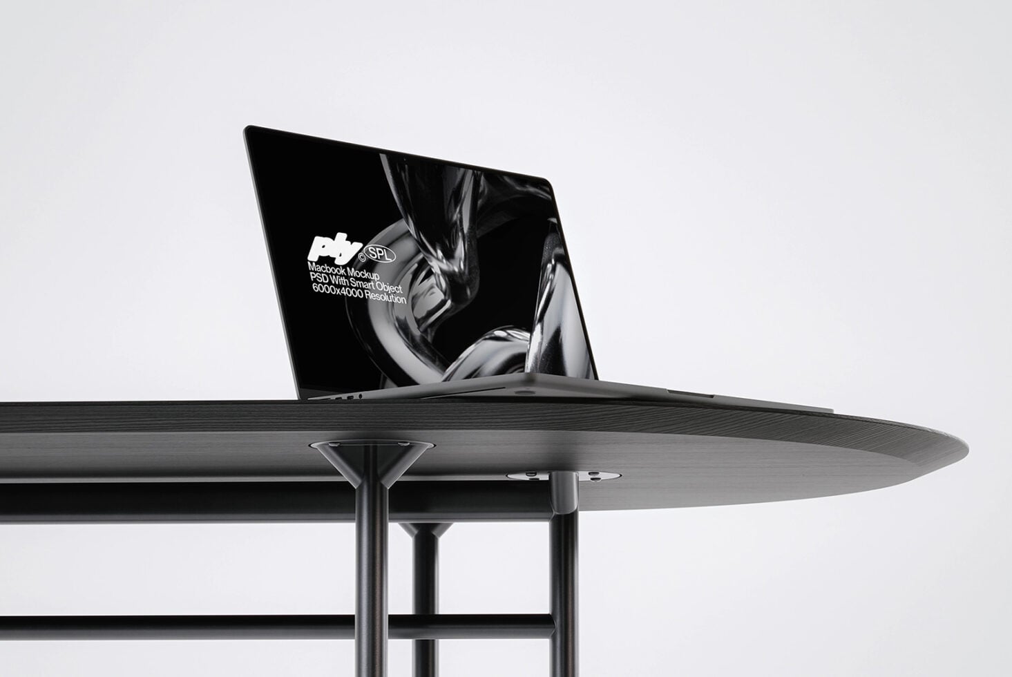 Side angle of blank macbook on contemporary dining setup