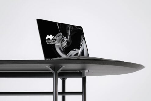 Side angle of blank macbook on contemporary dining setup