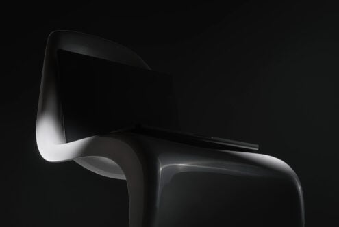 Modern black plastic chair with curved backrest studio product shot