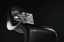Macbook on modern chair with liquid metal texture on screen