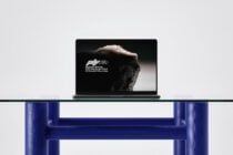 Laptop on shelf displaying mountain photography mockup with blue furniture