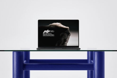 Laptop on shelf displaying mountain photography mockup with blue furniture