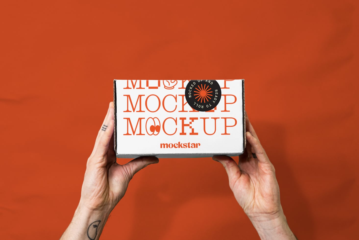 Hands holding small white box with orange text mockup on red background