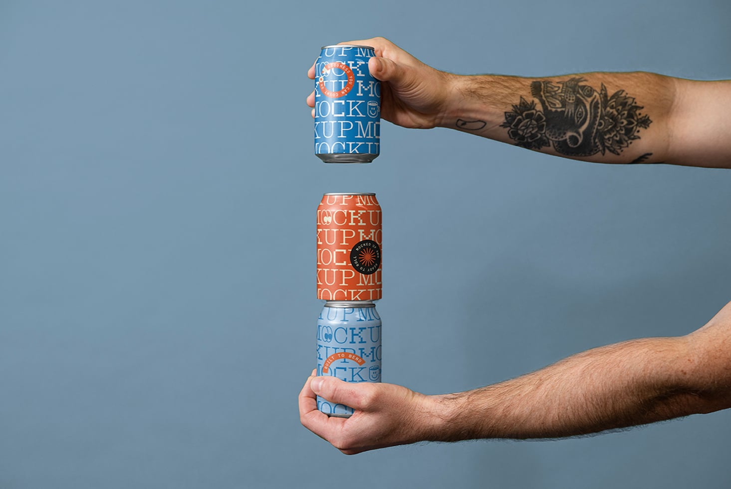 Hands stacking orange, white, blue cans with repeating text mockup layouts