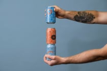 Hands stacking orange, white, blue cans with repeating text mockup layouts