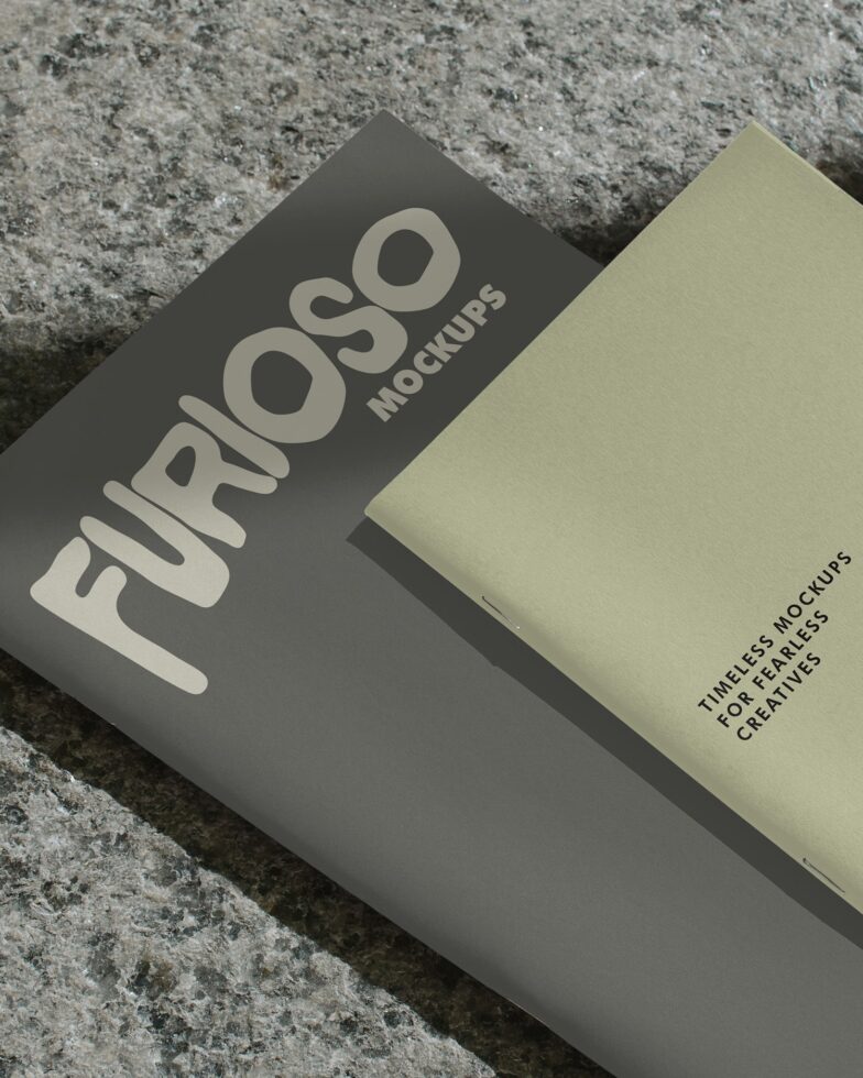 Two folded mockup cards on concrete surface in gray tones