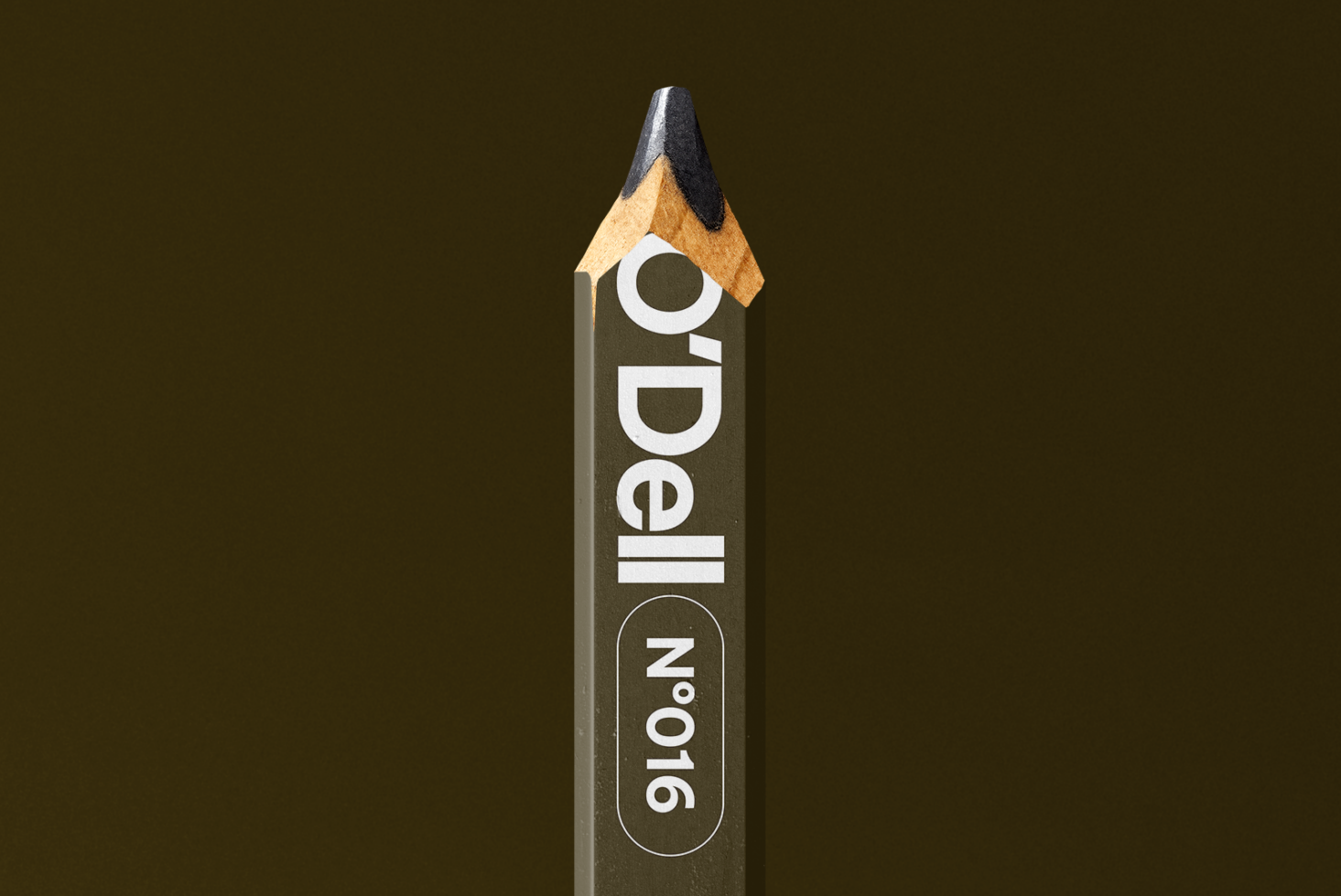 Wooden pencil mockup with O'Dell branding label against olive textured backdrop
