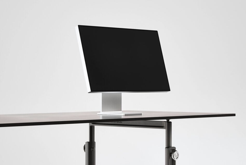 Modern monitor on pedestal base with blank black screen ready for mockup content