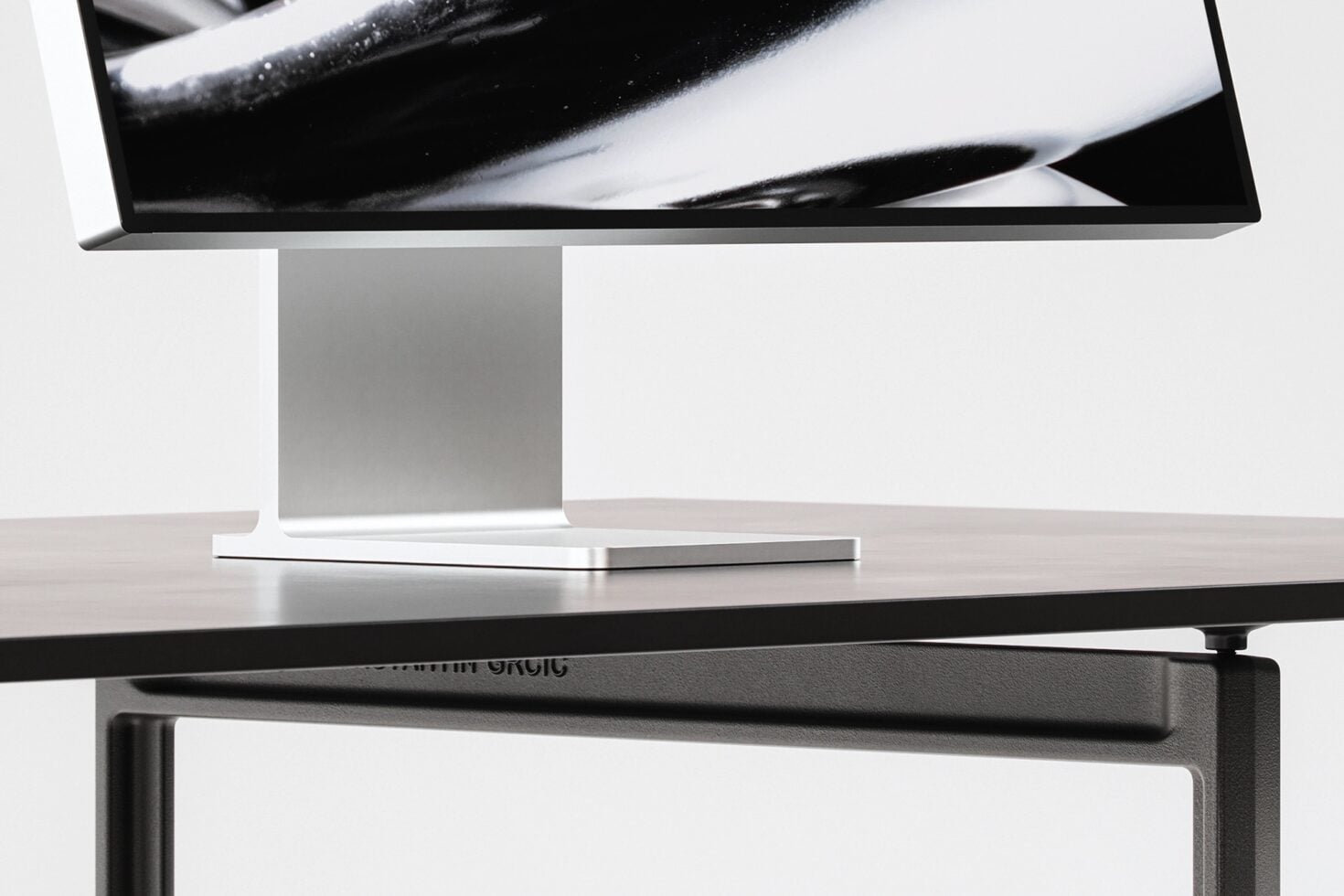 Desktop monitor on stand with adjustable arm showing abstract black brushstroke on screen
