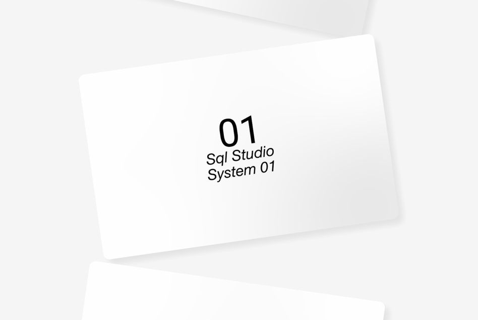 Tilted white card showing SQL Studio System 01 text in bold typography