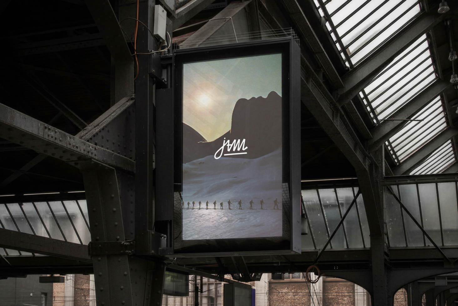 Mountain landscape billboard with jvmi logo above snowy terrain, industrial frame