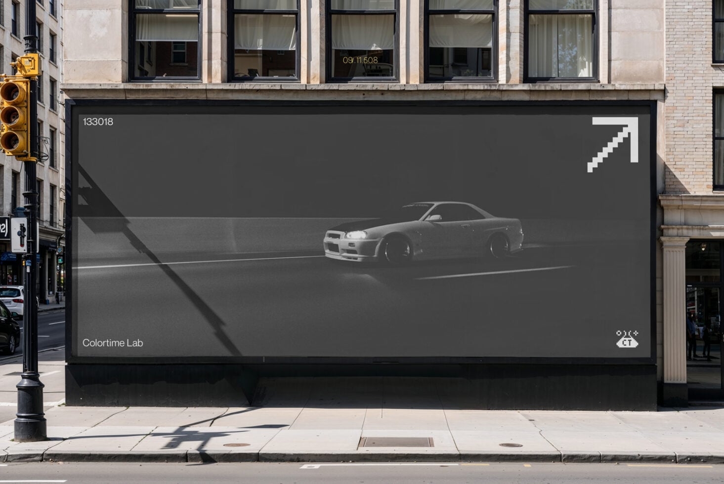 Large storefront billboard showing grayscale sports car with white pixel arrow
