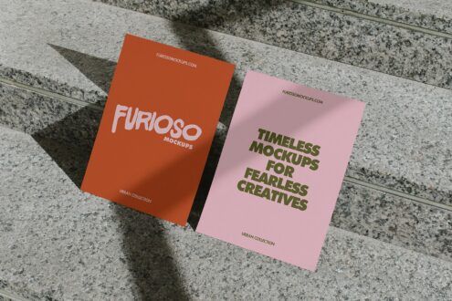 Two folded postcards on concrete surface, one orange one pink with FURIOSO branding