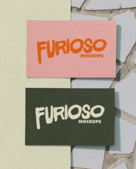 Business cards stacked in pink, cream, green on textured background