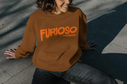 Overhead shot of person in caramel crewneck with orange Furioso logo