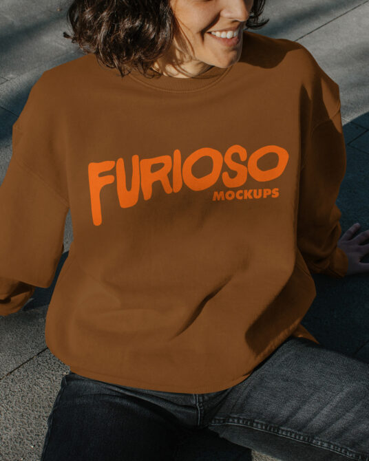 Person wearing tan sweatshirt with large orange Furioso text on chest
