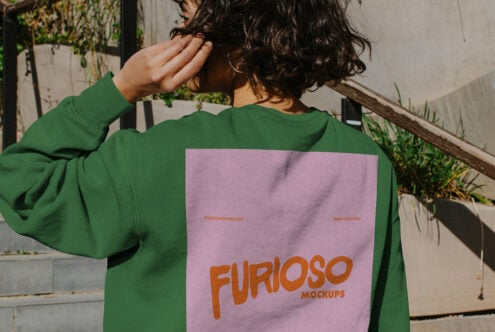 Outdoor shot of green sweatshirt with pink back graphic detail