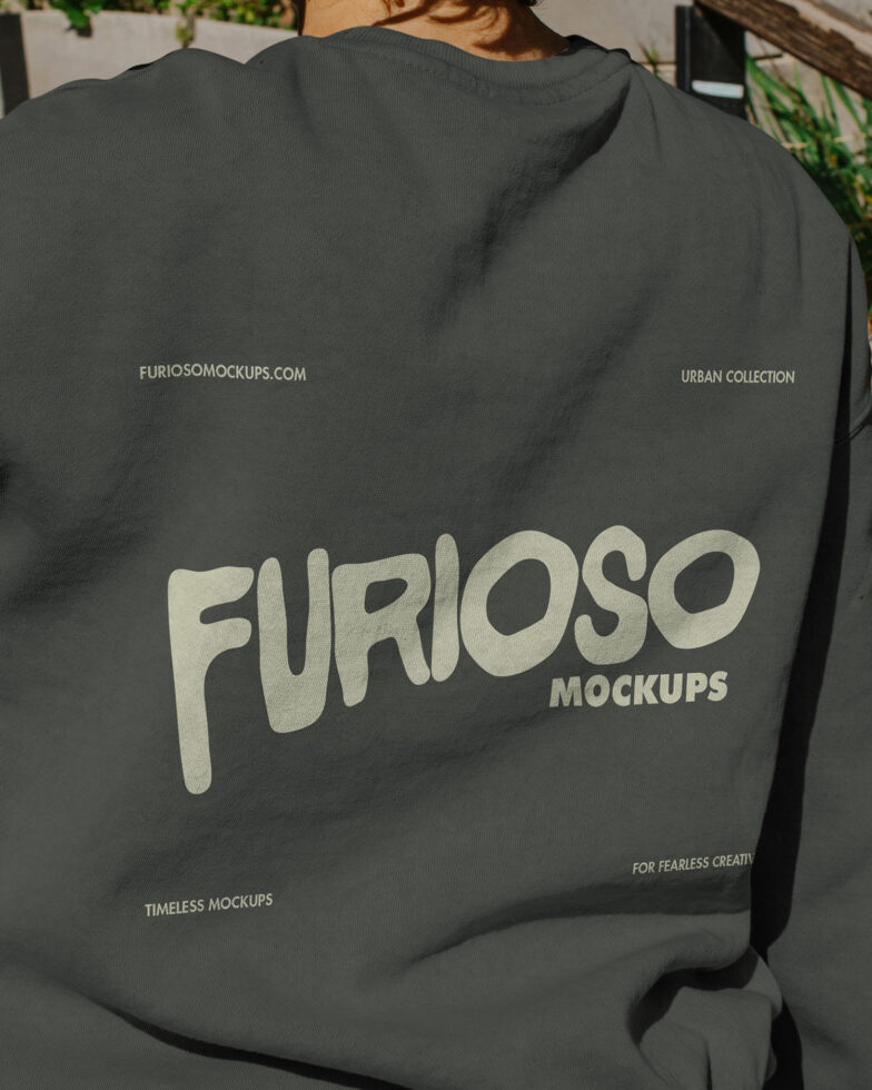 Back view of dark gray tee with large cream colored lettering
