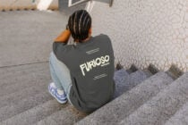 Person squatting showing charcoal sweatshirt back design from above