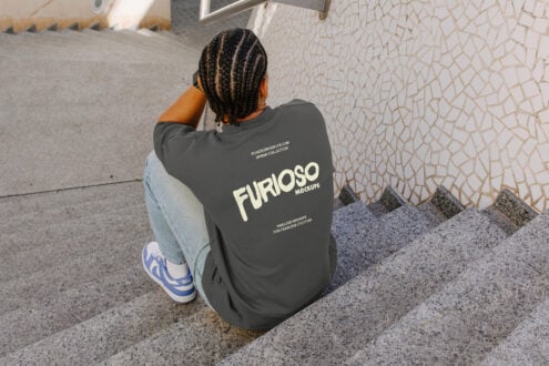 Person squatting showing charcoal sweatshirt back design from above