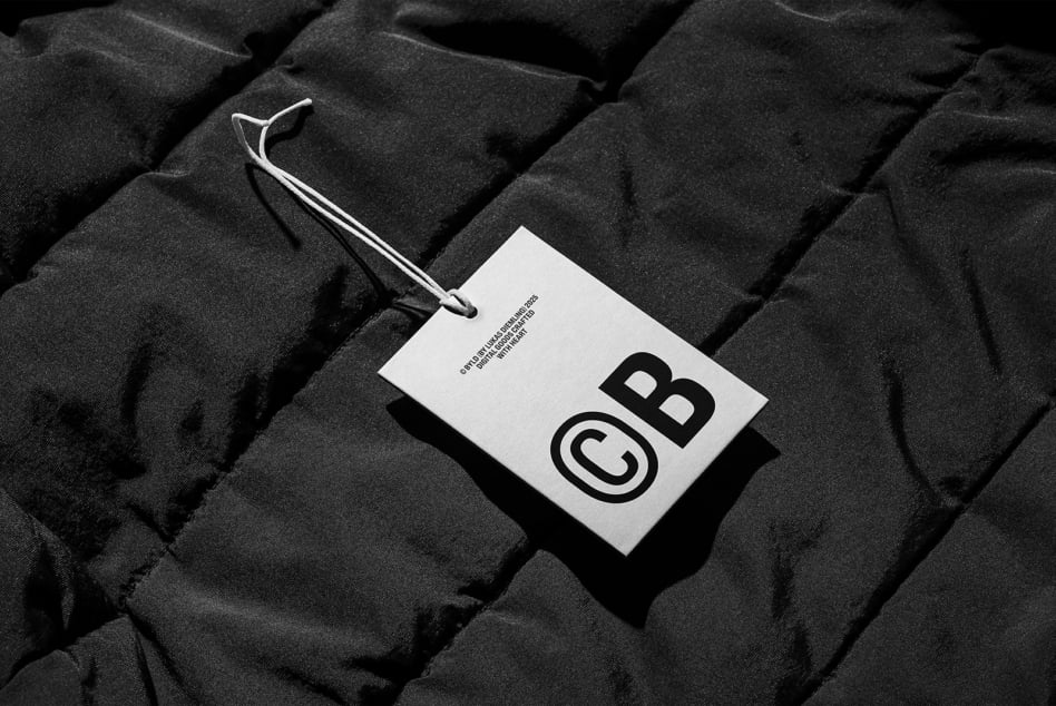 Minimalist clothing label mockup with curved metal hook detail