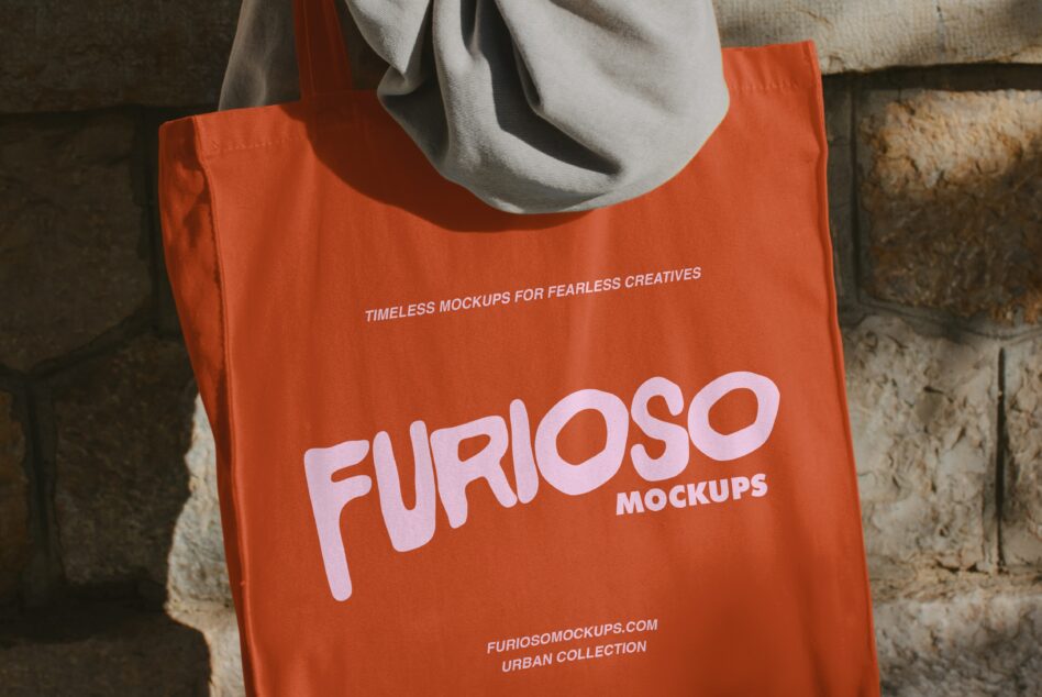 Bright orange tote bag with large pink FURIOSO logo worn over shoulder