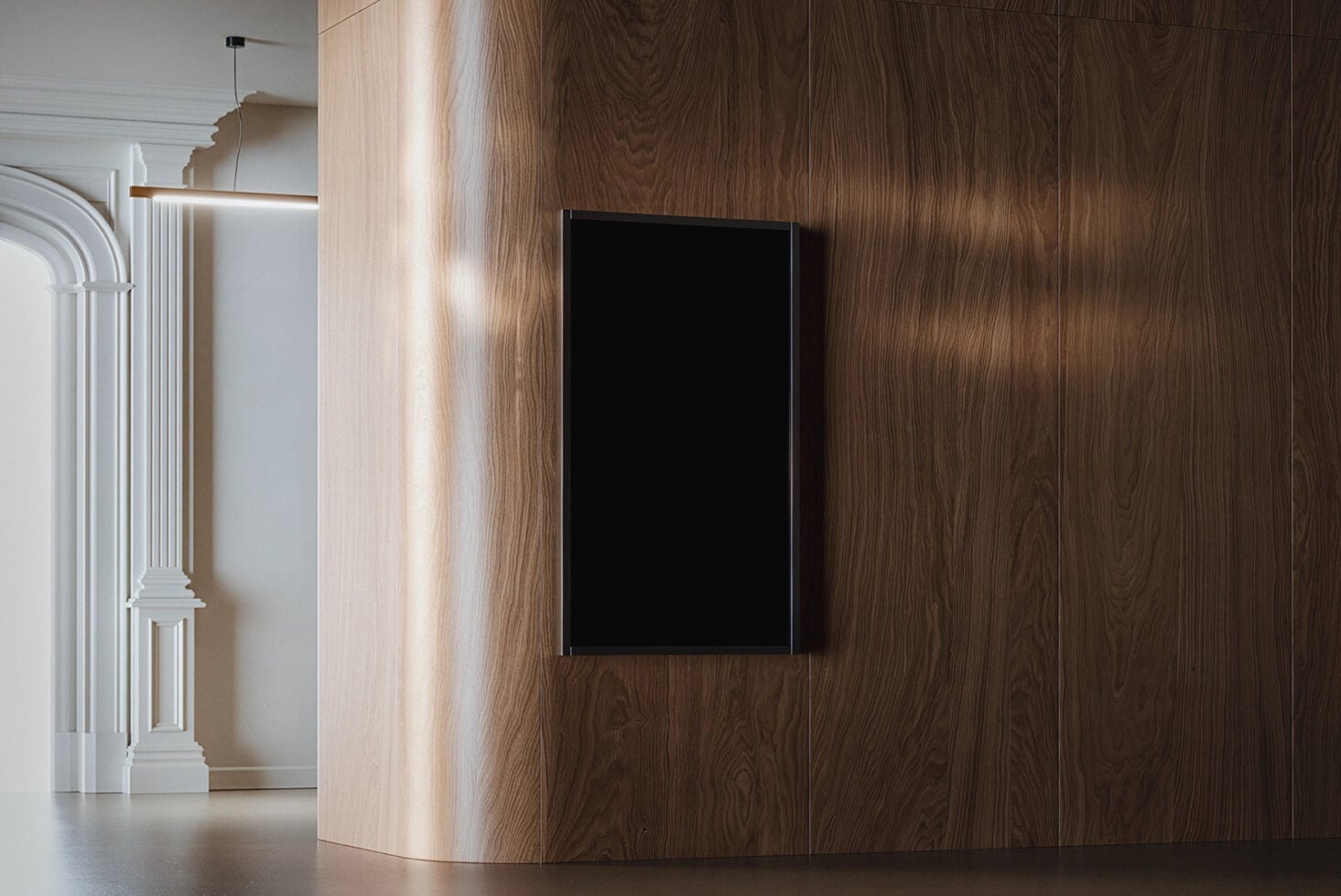 Empty black frame hanging on wooden wall next to white interior doorway